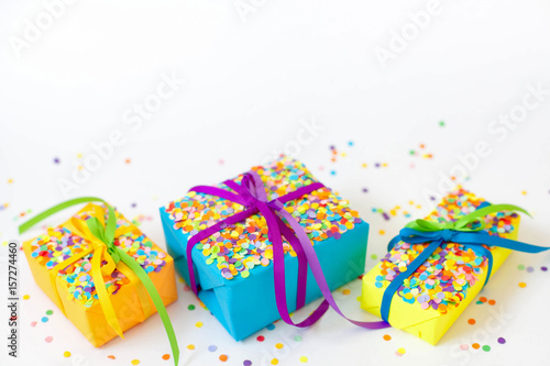 Colored gift boxes with colorful ribbons. White background. Gifts for Christmas or a birthday. 