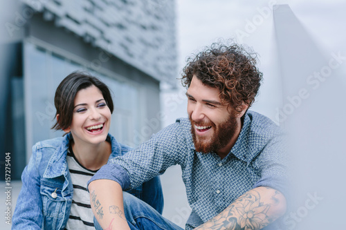 Young couple sitting and laughing photo