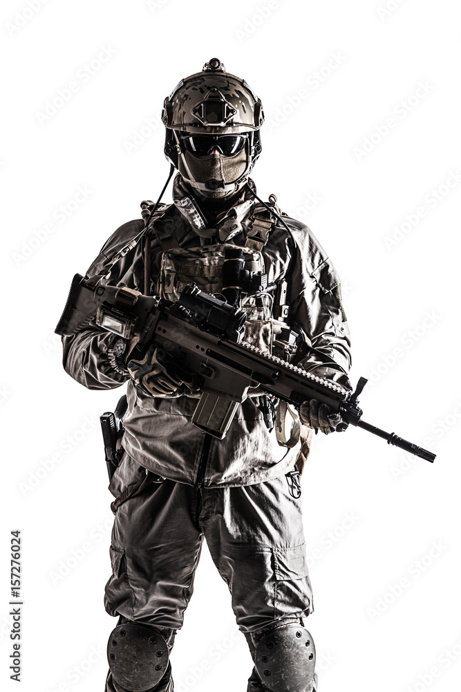 Army soldier in Protective Combat Uniform holding Special Operations Forces  Combat Assault Rifle. Studio shot, dark contrast, cropped, desaturated,  isolated on white background Stock Photo | Adobe Stock