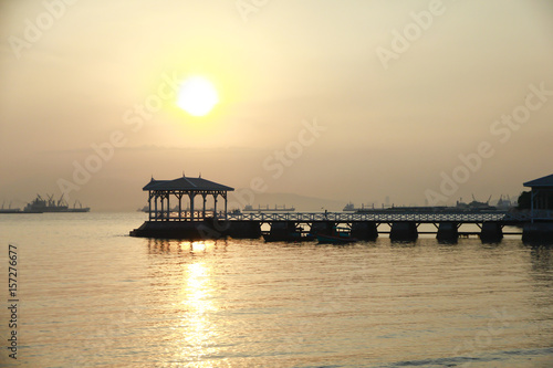 Stock Photo - wooded bridge in the port along sunrise. © singkamc