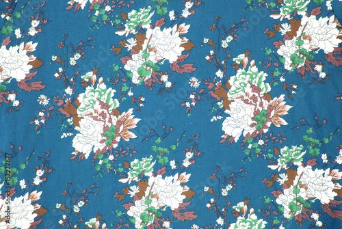 fabric pattern with classical image of the colorful flowers on blue background.