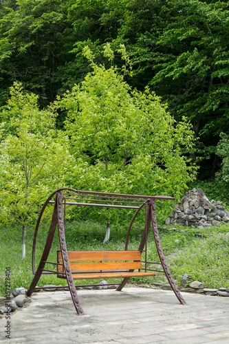 Swing chair, bench in the forest park