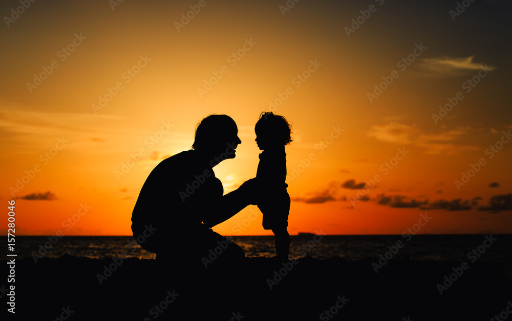 father and daughter talking on sunset beach
