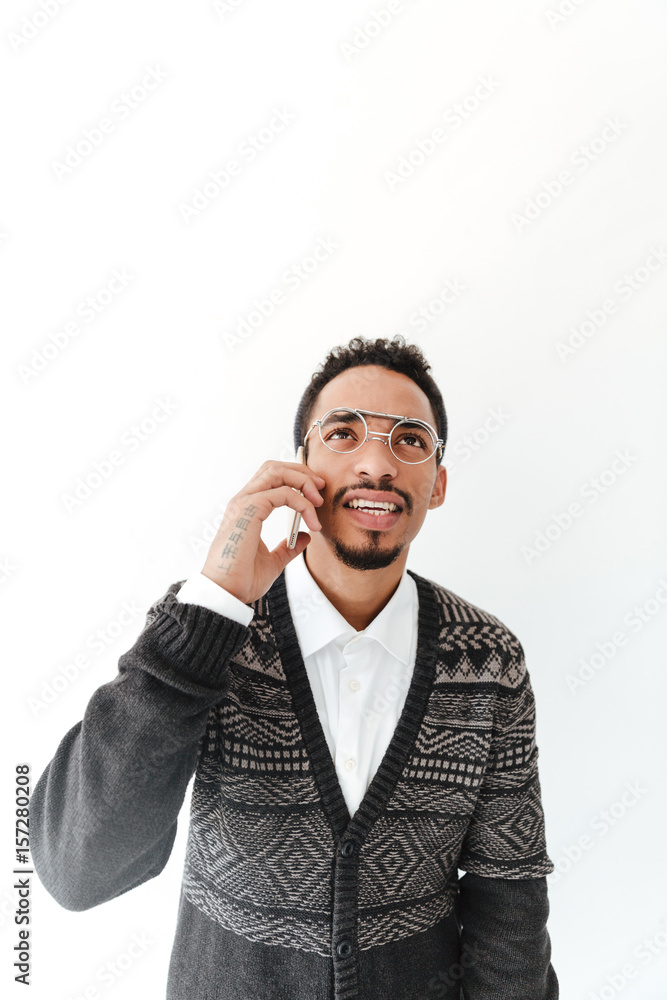 Concentrated young african man talking by phone. Concentrated young african man talking by phone.