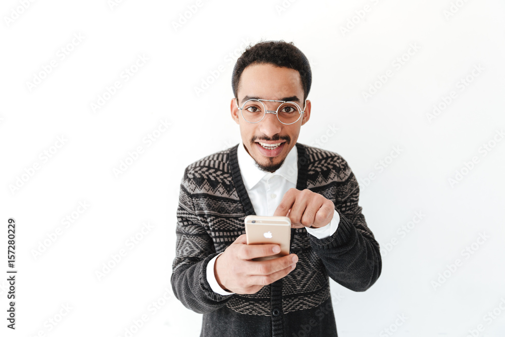 Happy young african man chatting by phone. Happy young african man chatting by phone.