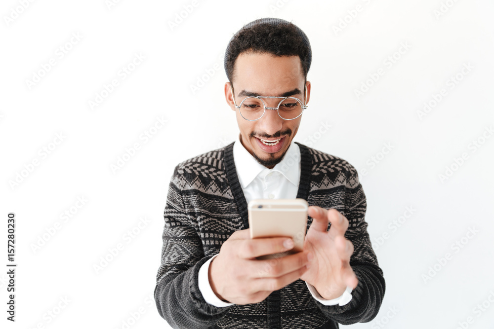 Happy young african man chatting by phone. Happy young african man chatting by phone.