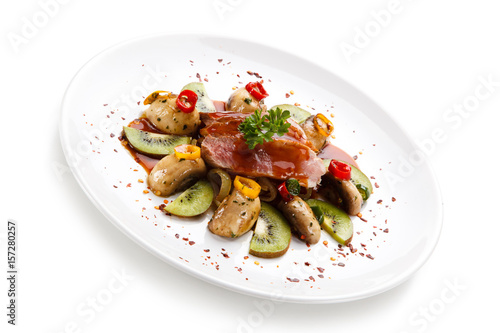 Carpaccio steak with vegetables and kiwi on white background