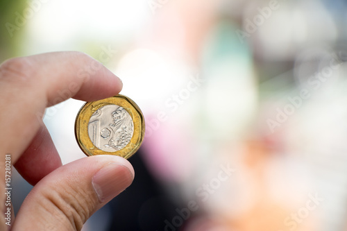 Business man hold one dollar singapore with blurred background