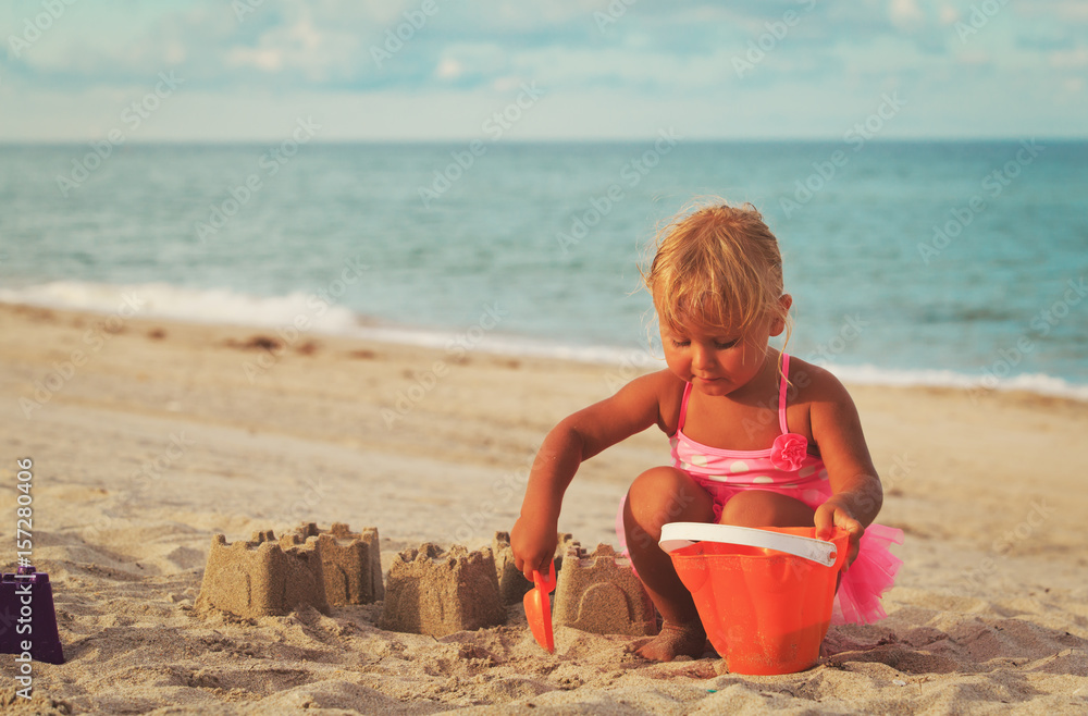 cute little girl play with sand on beach cute little girl play with sand on beach