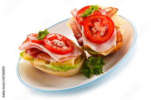 Sandwiches with meat, cheese and vegetables on white background