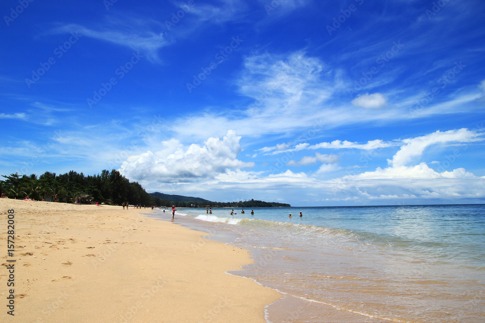 Travel to Island Koh Lanta, Thailand. The view on a beach with blue sea, cloudy sky and white sand on a sunny day. Travel to Island Koh Lanta, Thailand. The view on a beach with blue sea, cloudy sky and white sand on a sunny day.