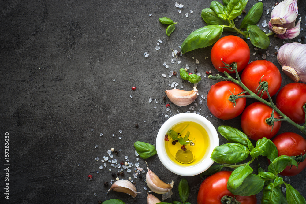 Ingredients for cooking. Vegetables olive oil tomato basil on black