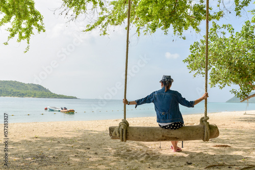 Girl on swing at the beach