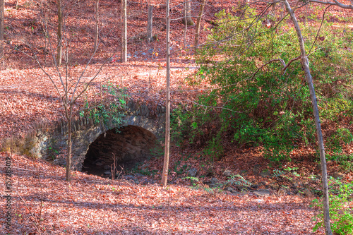 The stone bridge over the Ernest Richardson creek in the Lullwater Park in sunny autumn day, Atlanta, USA. photo