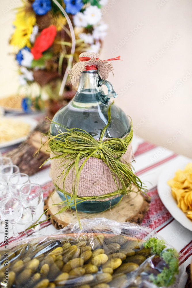 Bottle of vodka decorated with green ribbon