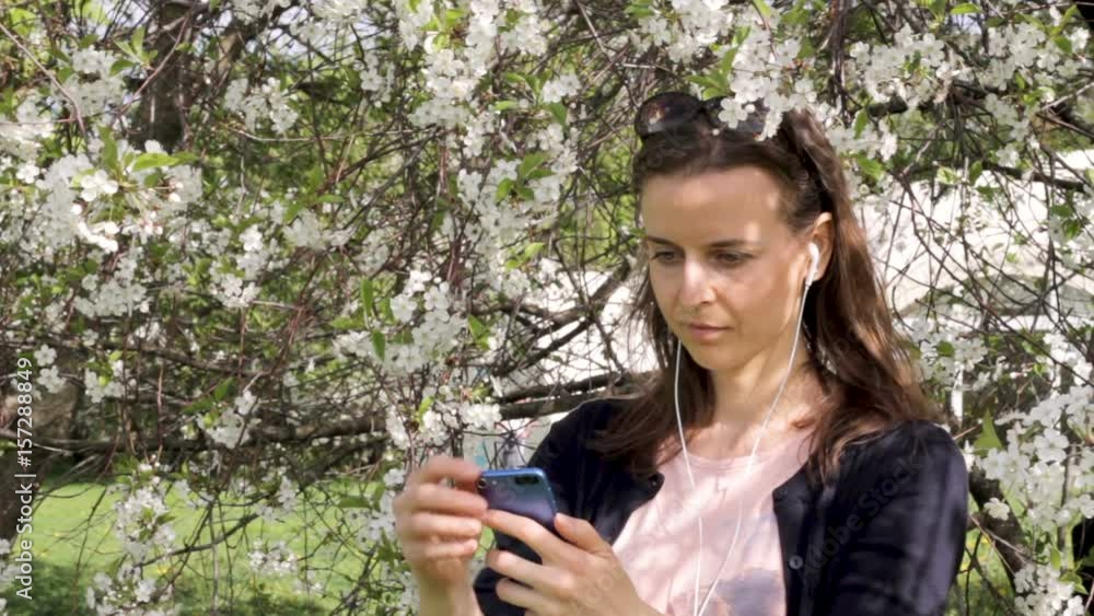 Young girl checking her mobile outdoors Young girl checking her mobile outdoors