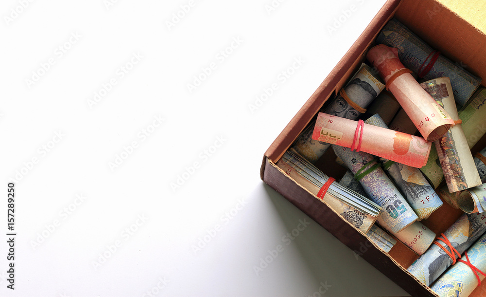 save money concept. Thai money in old paper box on white background. over light save money concept. Thai money in old paper box on white background. over light