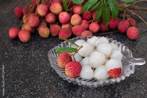 Litchi fruits. Fresh juicy lychee fruit on a glass plate. Peeled lychee fruit. photo