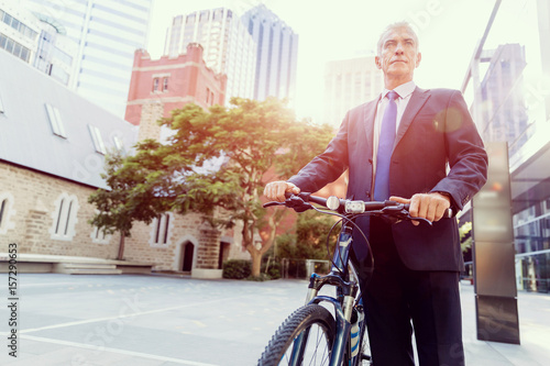 Successful businessman riding bicycle