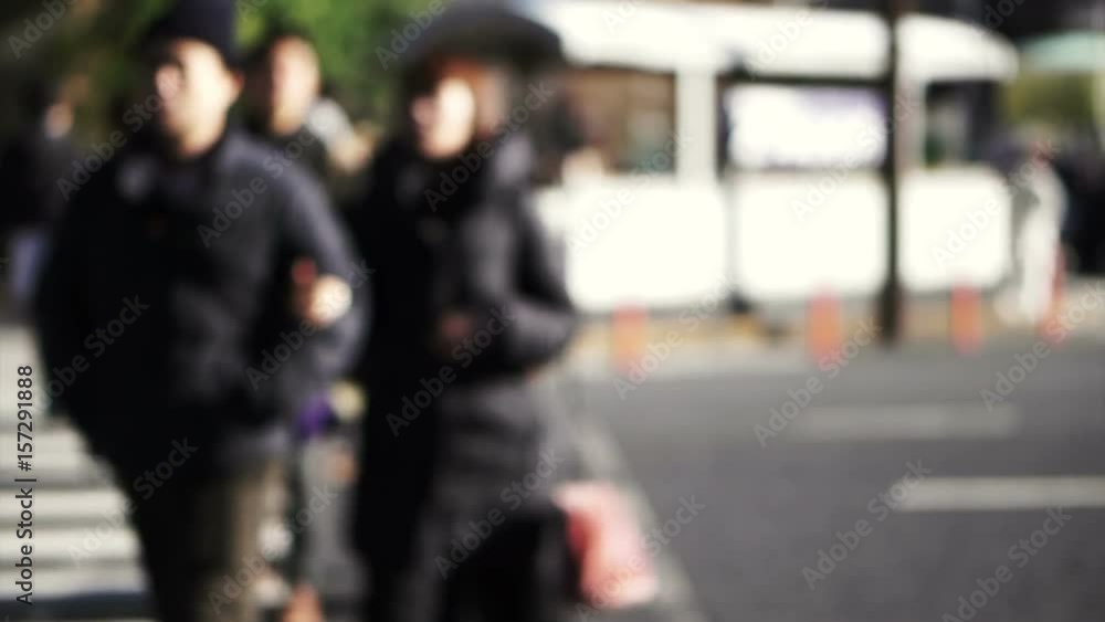 Blur shot of anonymous Japanese people walking in beautiful sun crossing and along pedestrian street in Tokyo Blur shot of anonymous Japanese people walking in beautiful sun crossing and along pedestrian street in Tokyo