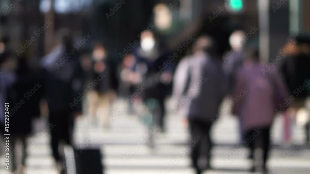 Blur shot of anonymous Japanese people walking in beautiful sun crossing and along pedestrian street in Tokyo Blur shot of anonymous Japanese people walking in beautiful sun crossing and along pedestrian street in Tokyo
