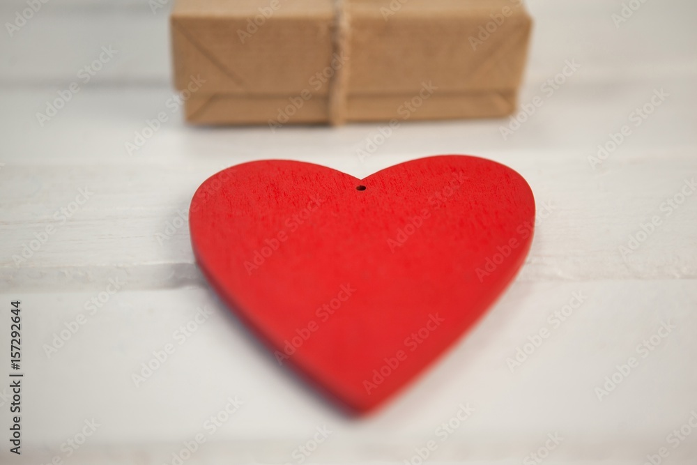 Heart shape by gift box on white table Heart shape by gift box on white table