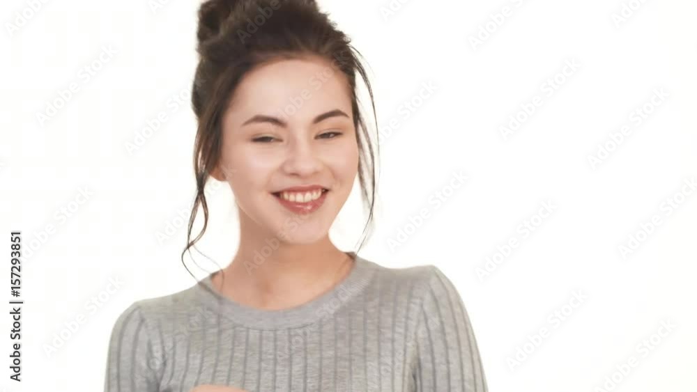 Beautiful brunette Caucasian girl flirting smiling looking at camera on white background
