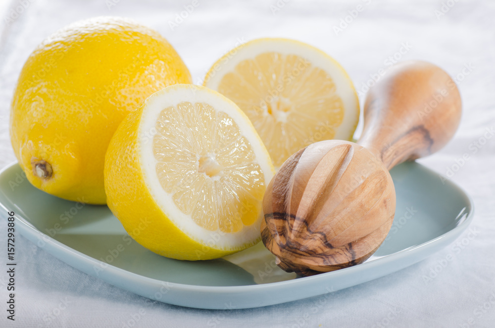Fresh lemons cut in half on blue plates Fresh lemons cut in half on blue plates