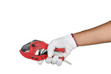 a hand with protection glove holding red scissors for cutting pl