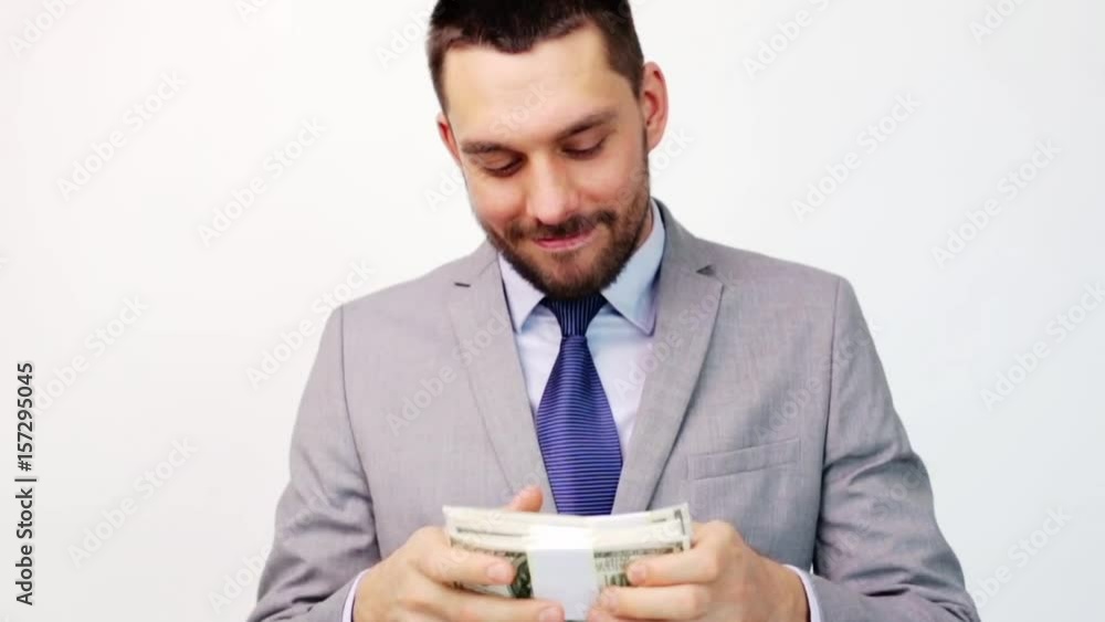 happy businessman with packets of dollar money happy businessman with packets of dollar money