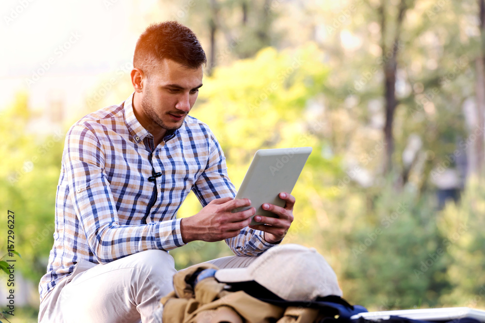 Young man with tablet computer working in the park Young man with tablet computer working in the park