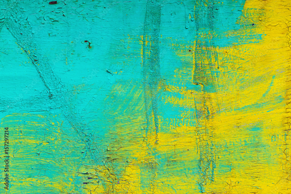 Closeup image of grunge colorful wall with peeling paint as an abstract background.
