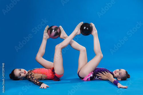 Two caucasian gymnasts with a ball