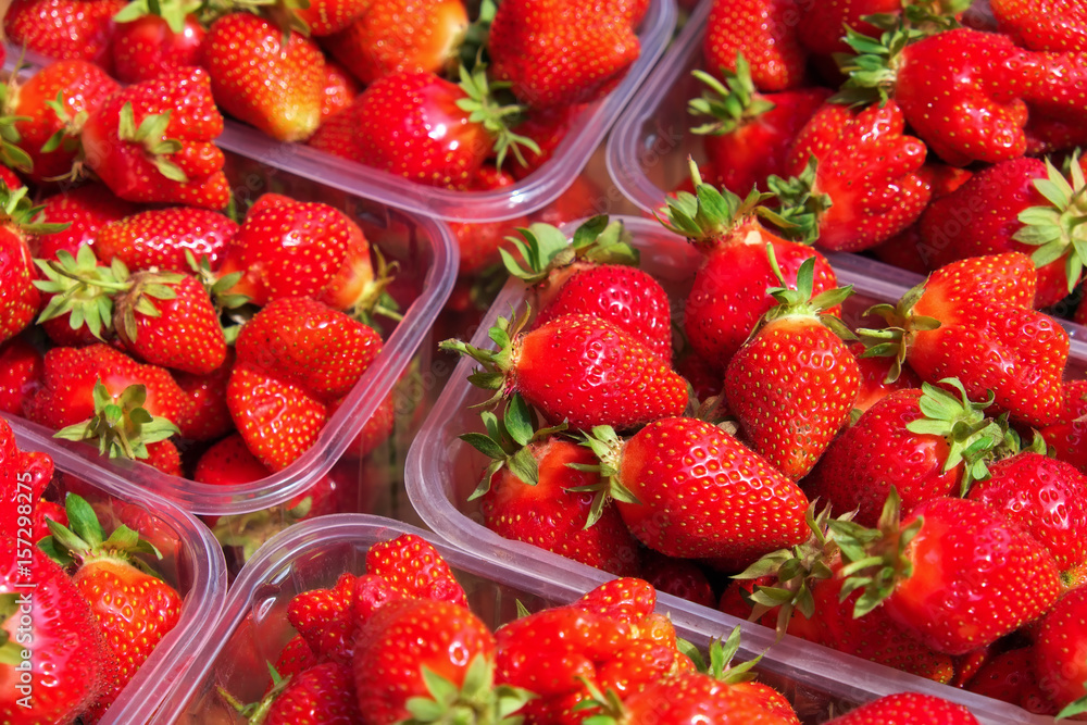 Tasty juicy strawberry berries in boxes, on the market Tasty juicy strawberry berries in boxes, on the market