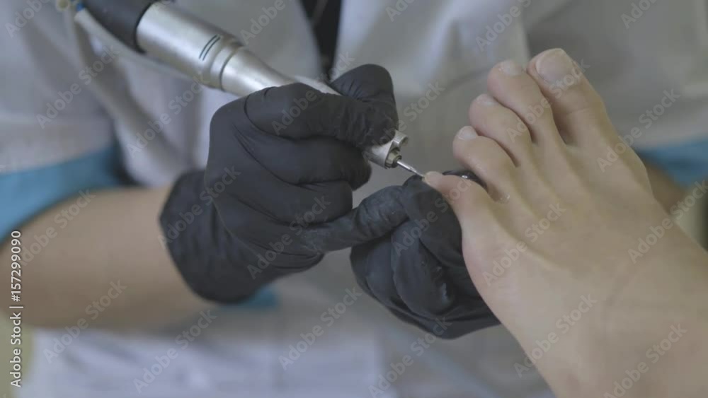 Removing fingernail cuticles with drill machine, polishing. Pedicure
