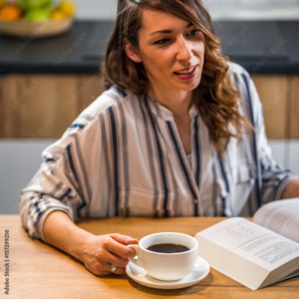 Woman drinking coffee and reading book Woman drinking coffee and reading book