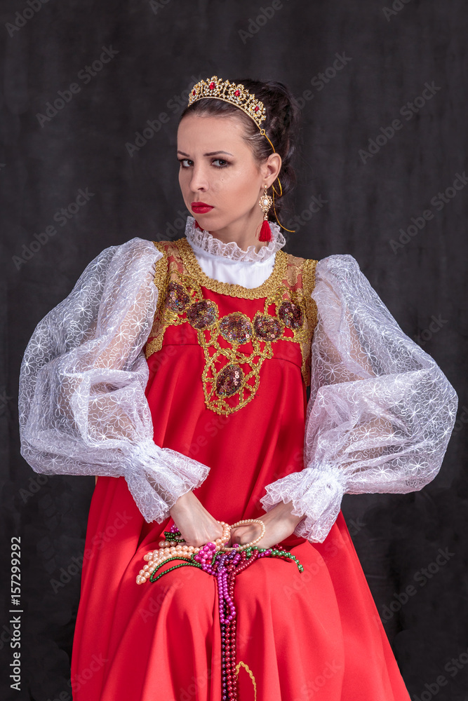 Portrait of a young girl with dark hair in a Russian costume