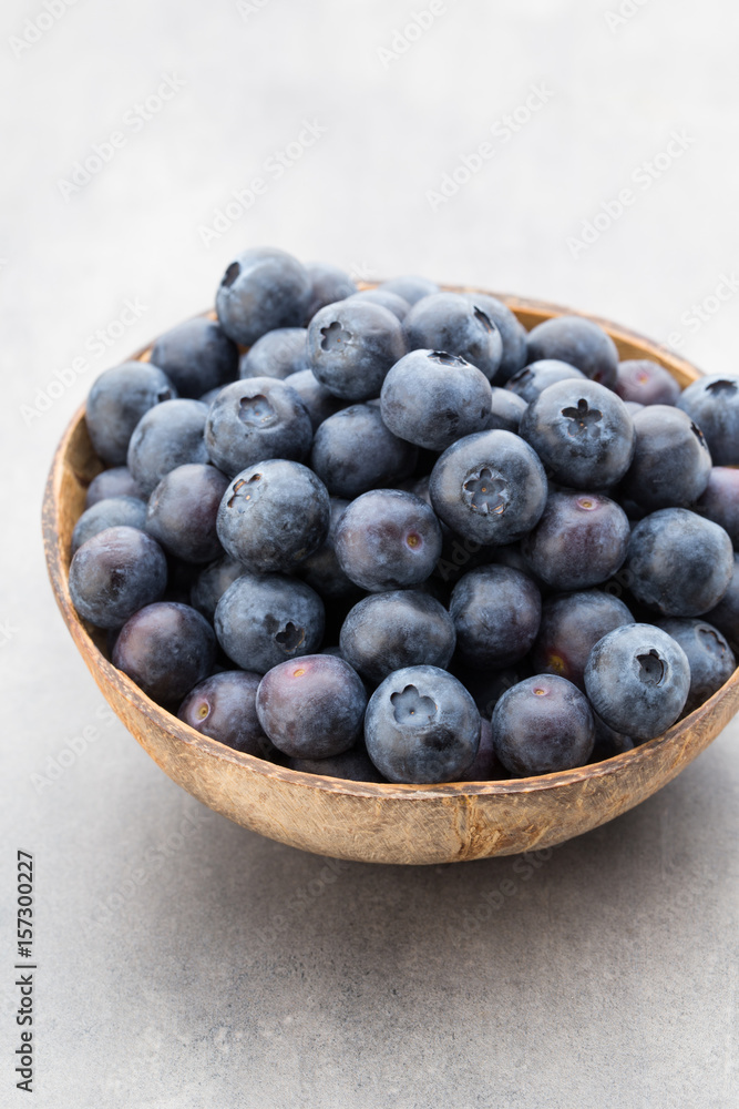 Fresh blueberries natural coconut in a bowl on a gray background. Fresh blueberries natural coconut in a bowl on a gray background.