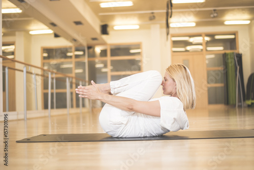 Woman practicing yoga in knee press pose