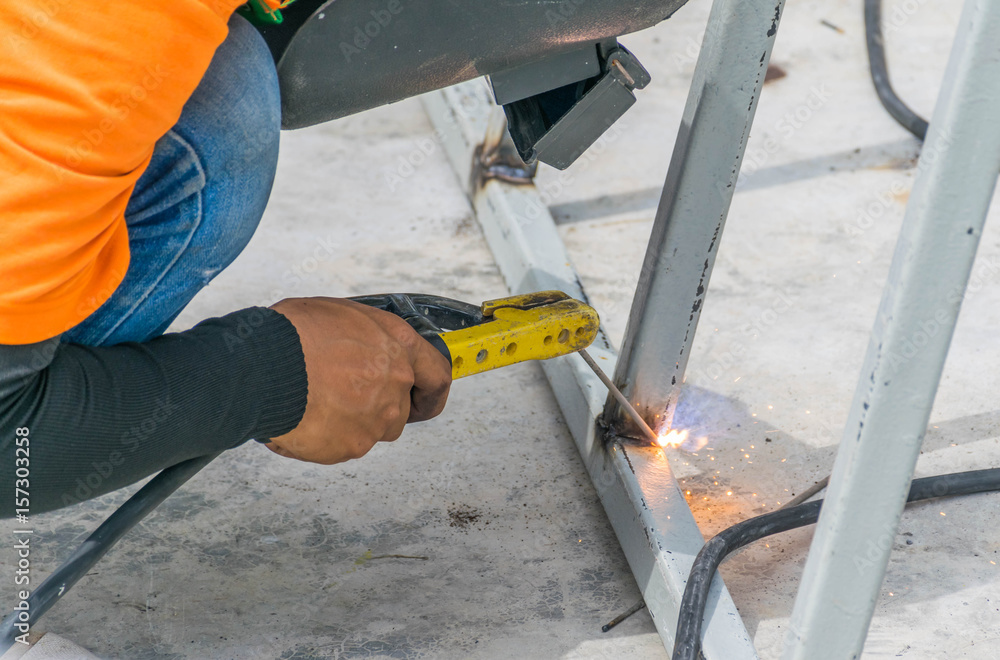 Welder works on the building of a house Welder works on the building of a house