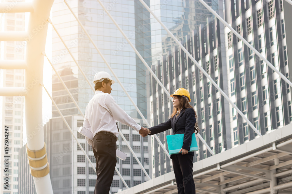 Two engineers handshake to congratulate the successful work. Two engineers handshake to congratulate the successful work.