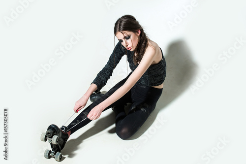 sexy girl on rollers with fashionable makeup, long brunette hair