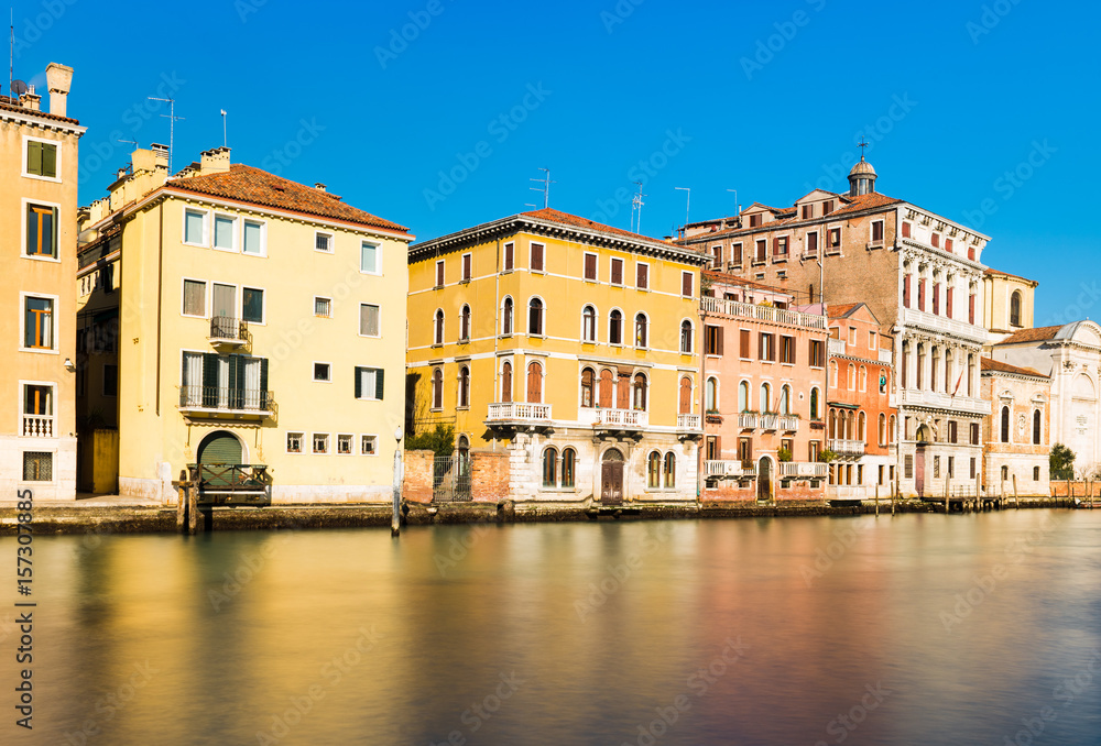 The street of Venice, historical buildings in the traditional Venetian style reflected in canal with water, Veneto region, Italy