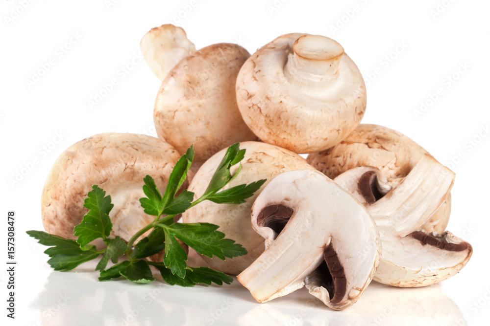 A bunch of champignon mushrooms with leaf parsley isolated on white background A bunch of champignon mushrooms with leaf parsley isolated on white background