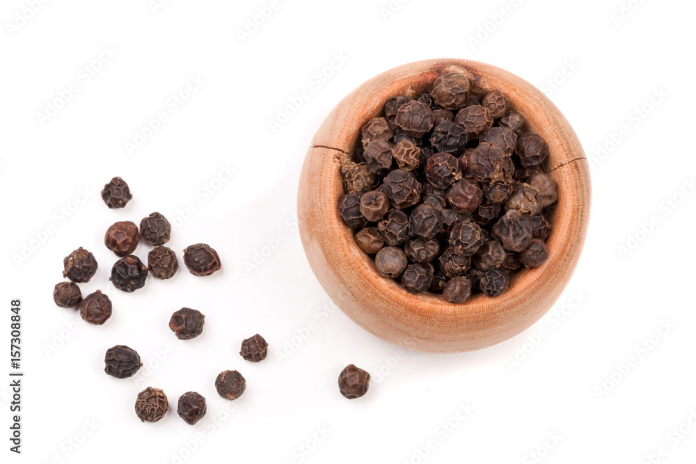Black peppercorn in a wooden bowl isolated on white background. Top view Black peppercorn in a wooden bowl isolated on white background. Top view