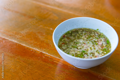 Thai style chilli spicy sauce dipping on wood table, seafood hot dip. photo