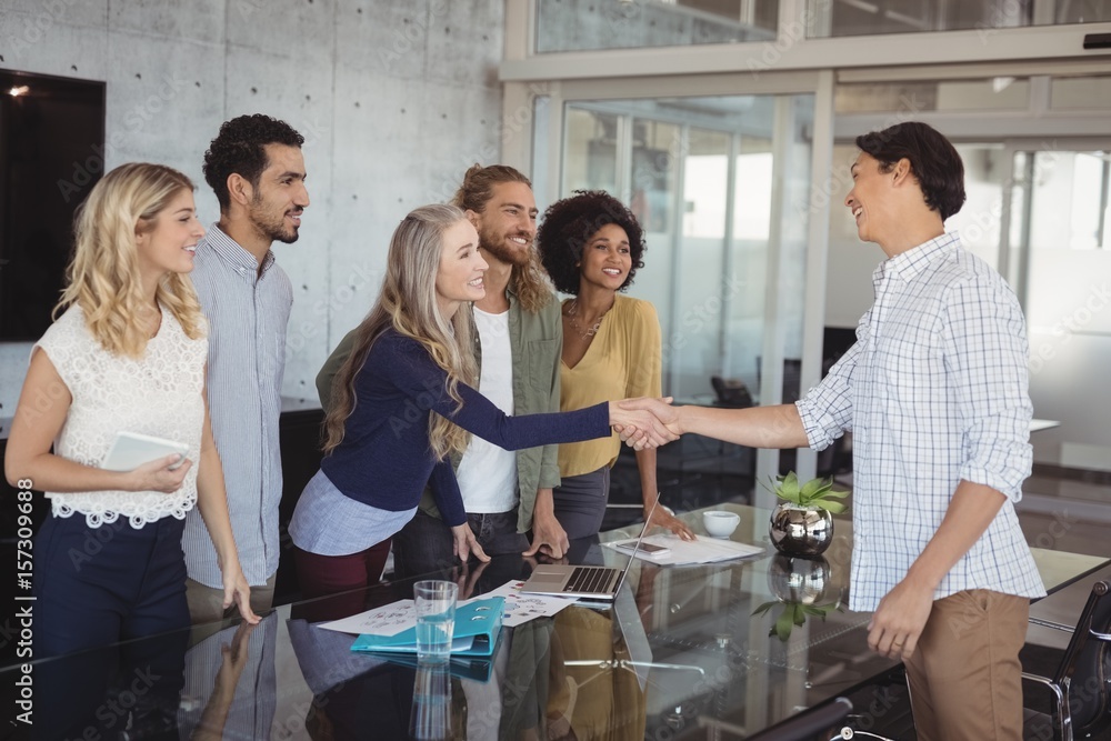 Fototapeta premium Business people shaking hand at creative office