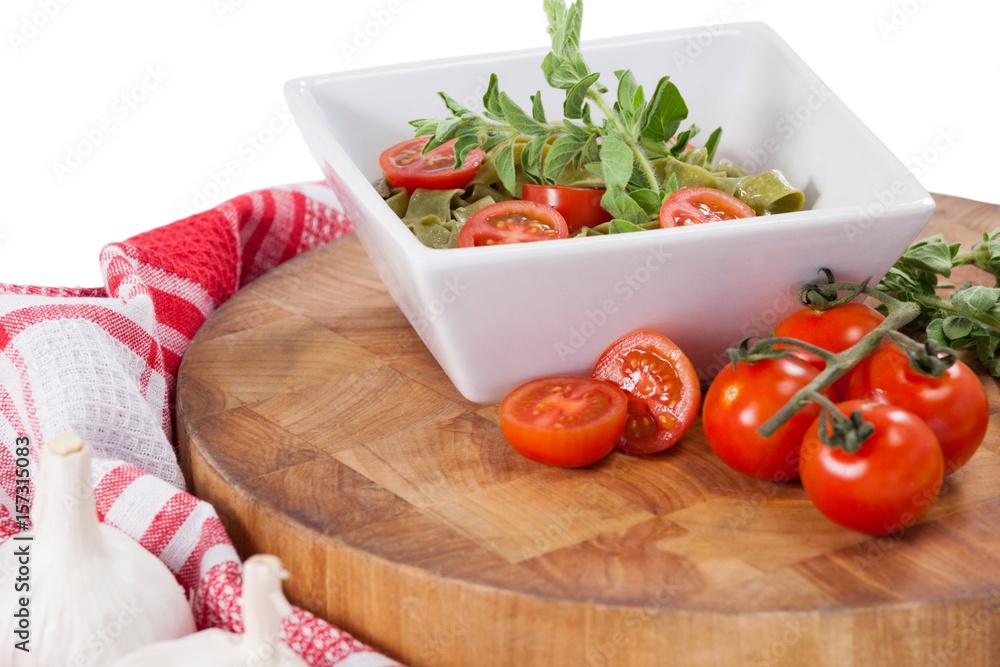 Fettuccine spinach pasta with tomatoes, garlic and napkin cloth Fettuccine spinach pasta with tomatoes, garlic and napkin cloth