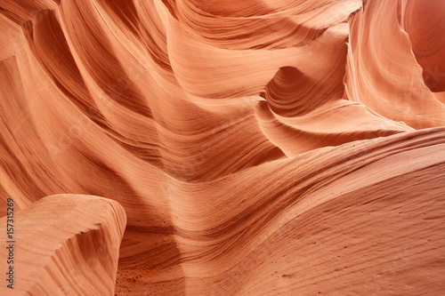 Nature red sandstone textured background. Swirls of old red  sandstone wall abstract pattern in Lower Antelope Canyon, Page, Arizona, USA.