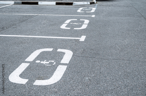 Parking for cars, places for the disabled, sign on the asphalt.